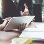 Business woman and lawyers discussing and using digital tablet  on wooden desk in office. Law, legal services, advice, Justice concept.